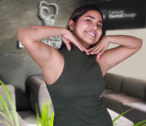 young woman at cancun dental design smiling with her braces