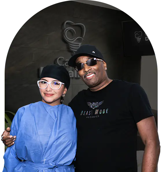 black woman patient at cancun dental design smiling with his snap-on dentures