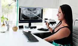 cancun dental design front desk manager giving assistance on dental insurance coverage