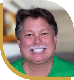 patient of cancun dental design ponting at his perfect smile with veneers